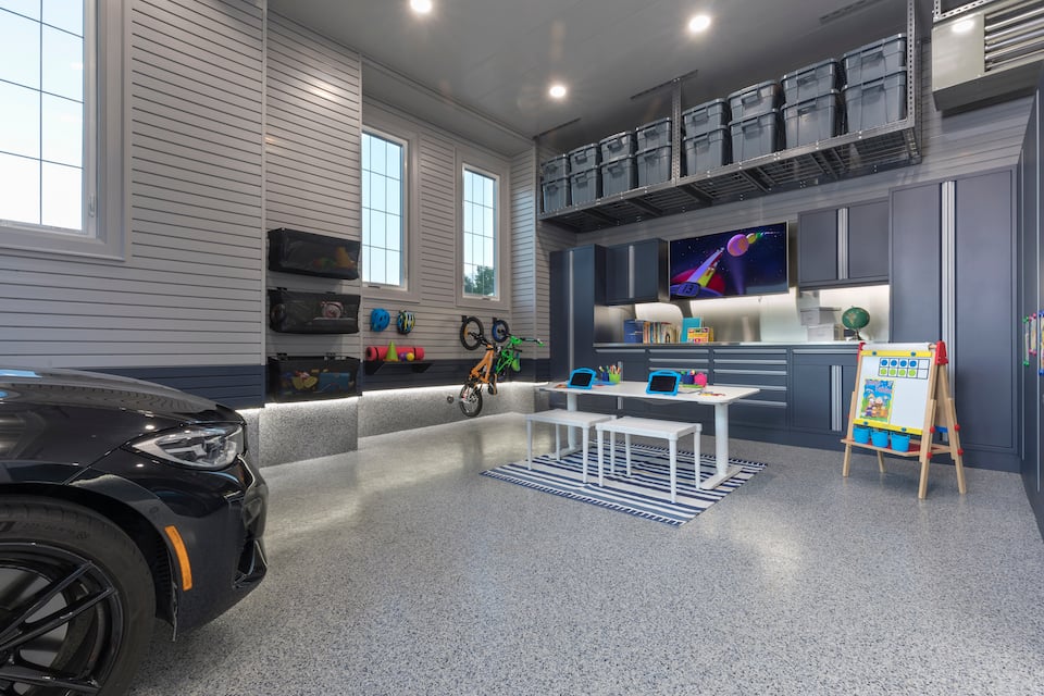 black car in garage with student desk and chairs