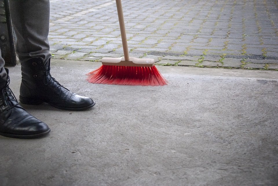 person-sweeping-garage